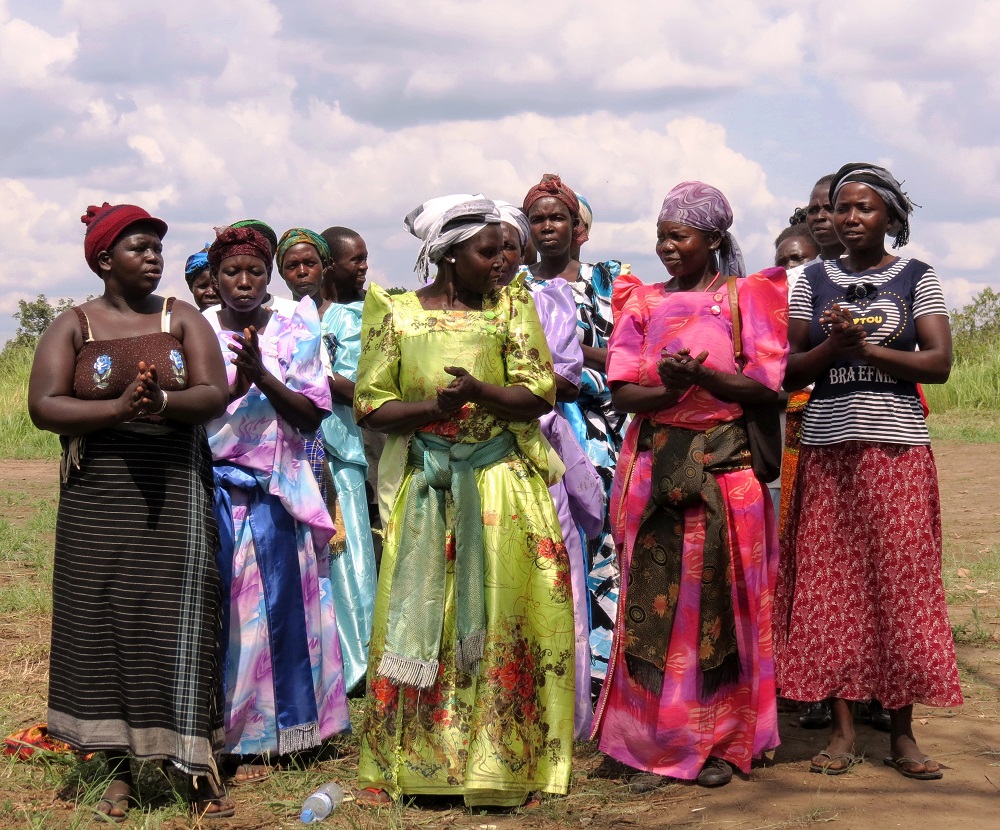 Lutuk parents in colourful dresses for African Revival village saving scheme and loan schemes